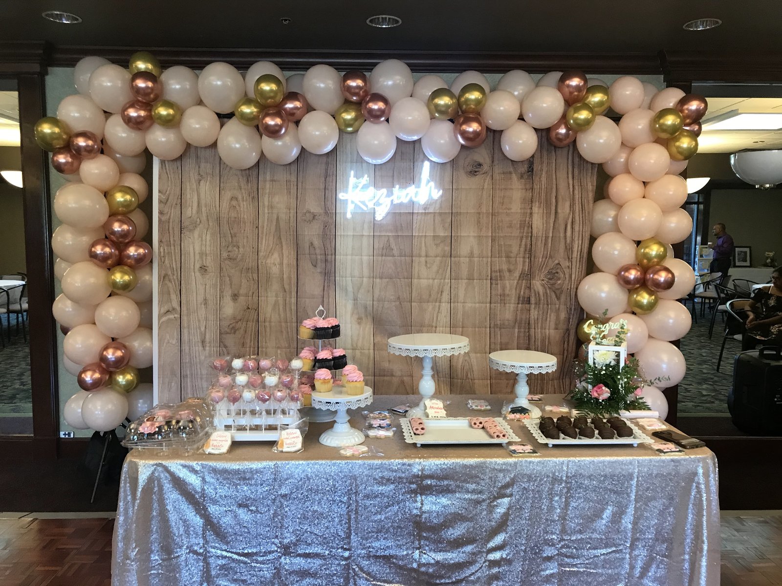 Balloon arch over a graduation dessert table