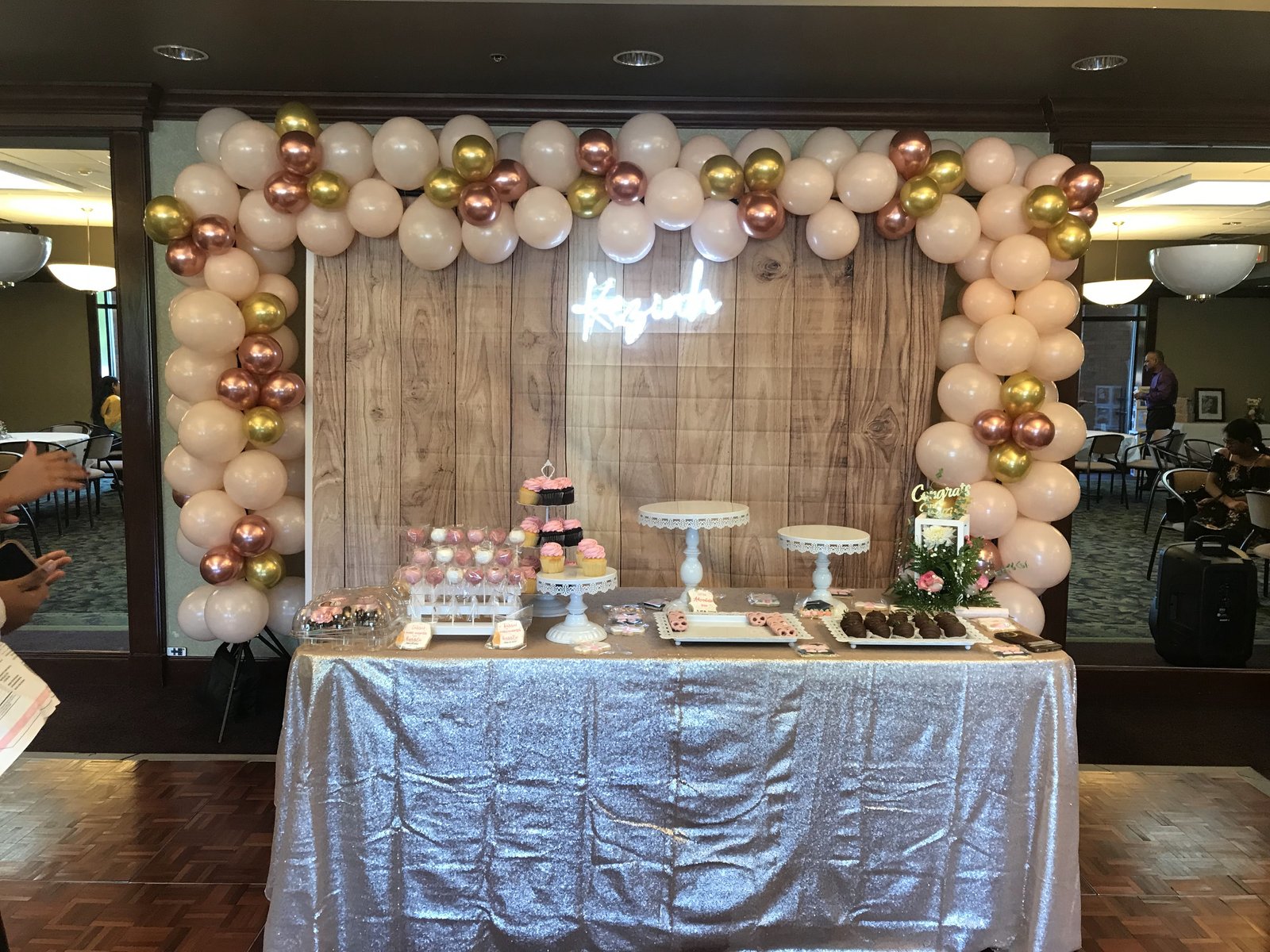 Blush and gold balloon arch with neon name sign
