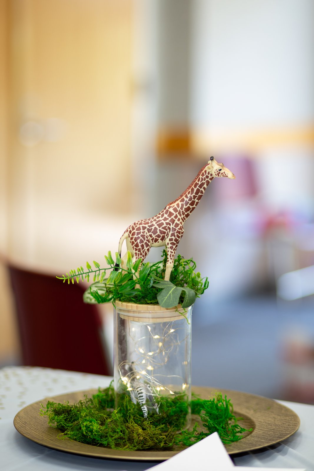 Giraffe safari centerpiece with moss and fairy lights