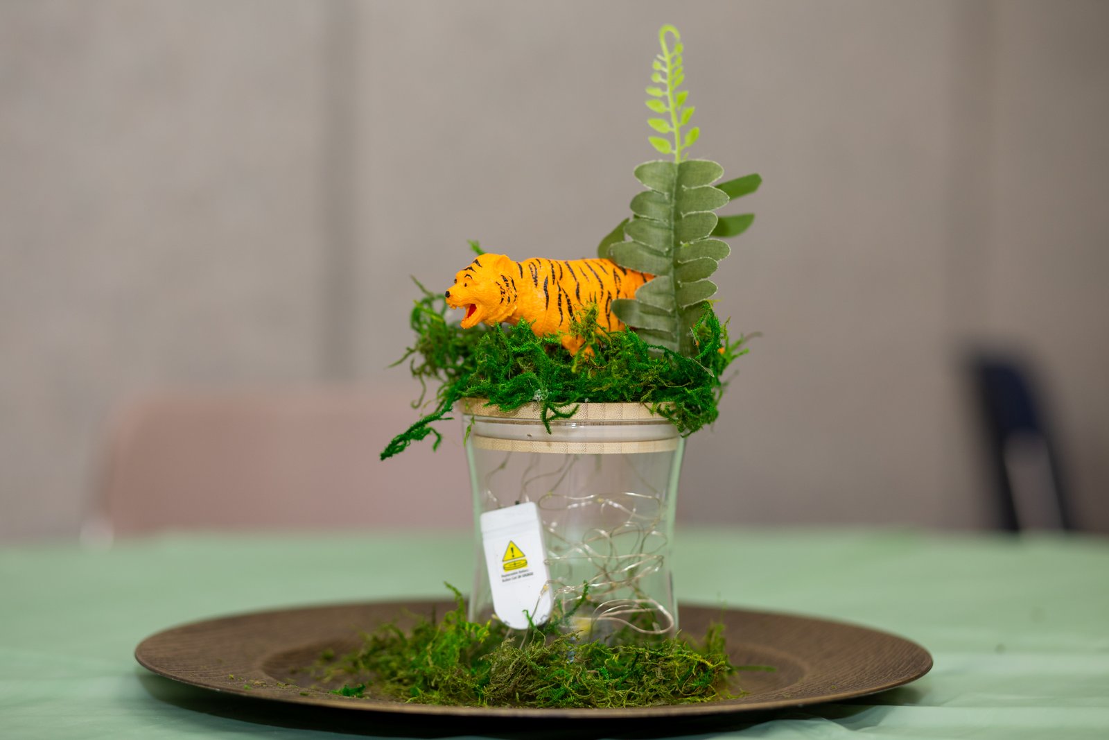 Tiger safari centerpiece with fern and fairy lights